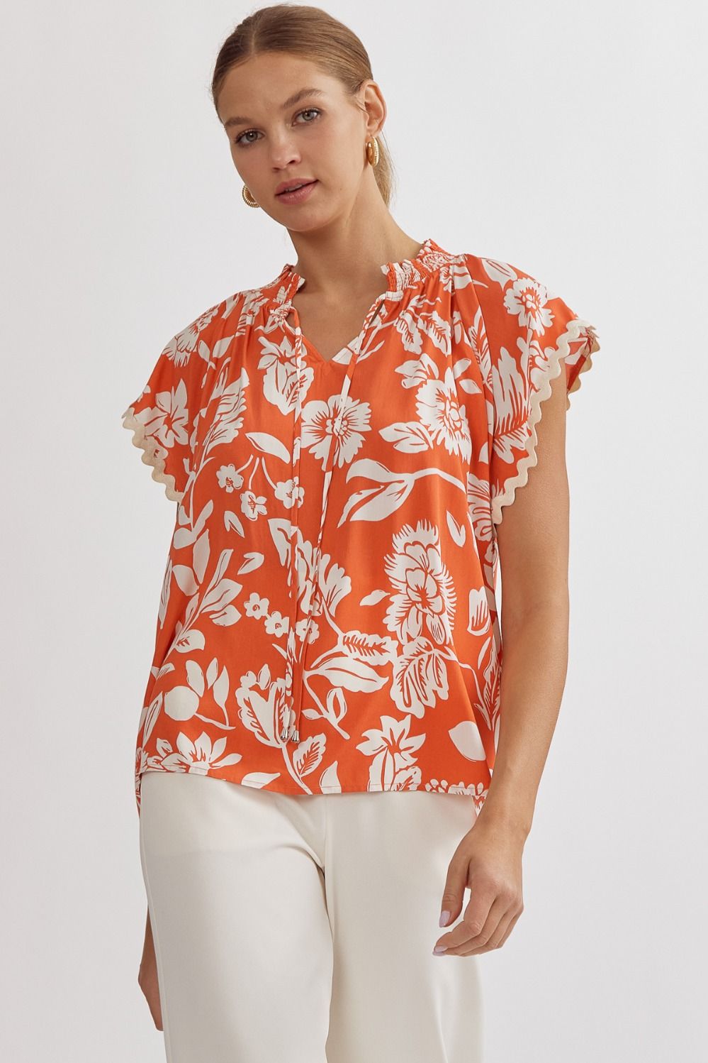 orange and white floral sleeveless top
