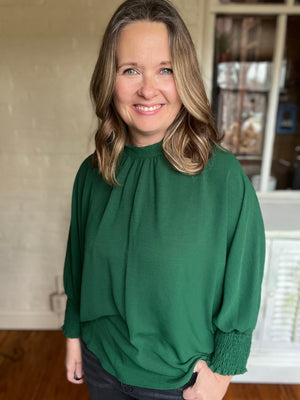 green holiday top with bow accents